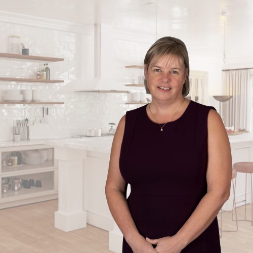 Sue full photo with kitchen background